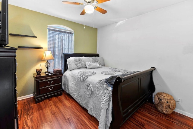 bedroom featuring ceiling fan, baseboards, and wood finished floors