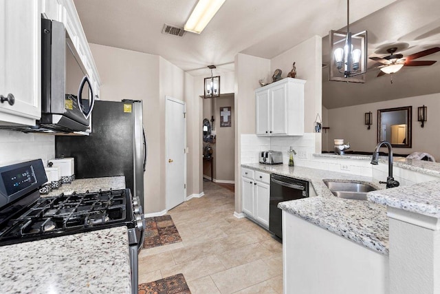 kitchen with appliances with stainless steel finishes, a sink, decorative light fixtures, and white cabinets