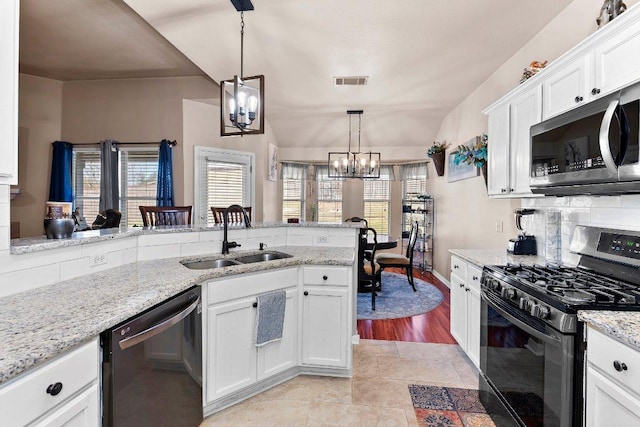 kitchen featuring a sink, visible vents, dishwasher, stainless steel microwave, and range with gas cooktop