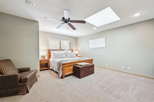 bedroom featuring baseboards, a skylight, recessed lighting, ceiling fan, and carpet flooring