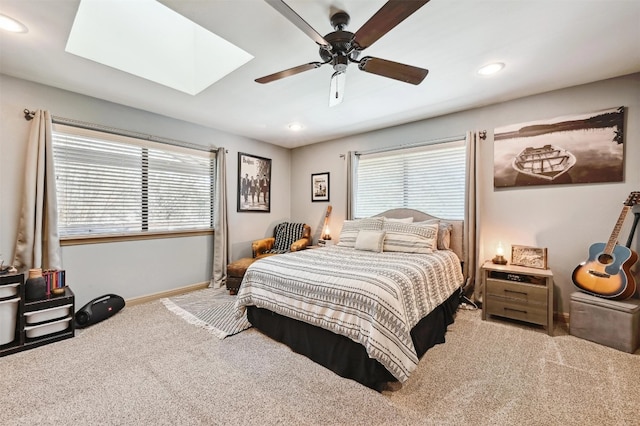 carpeted bedroom featuring recessed lighting, baseboards, multiple windows, and a skylight