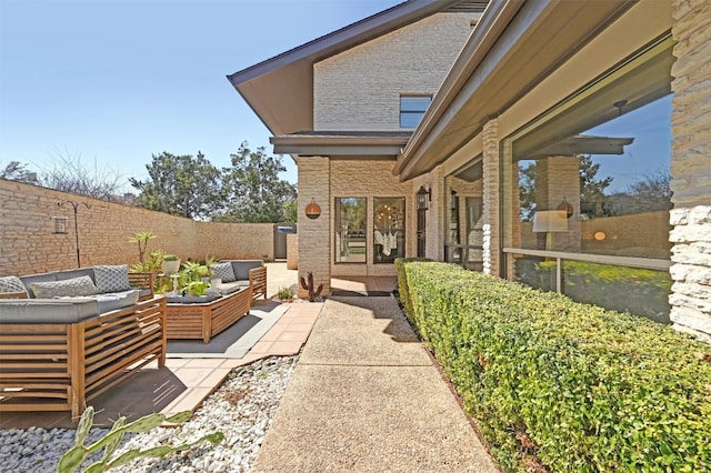 view of patio featuring outdoor lounge area and a fenced backyard