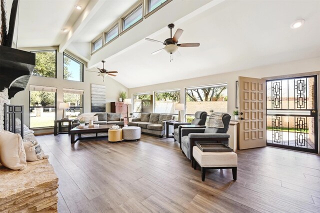 living room with beam ceiling, high vaulted ceiling, a ceiling fan, and wood finished floors