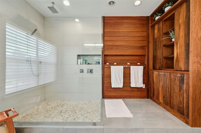 bathroom with tile patterned floors and a walk in shower