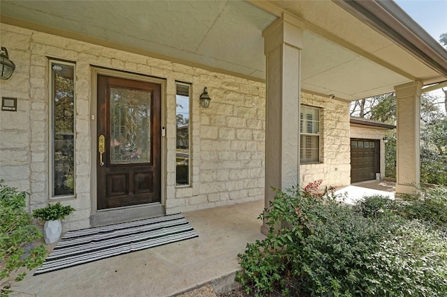 view of exterior entry with a porch