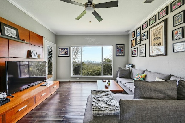 living area with baseboards, dark wood finished floors, a ceiling fan, and crown molding