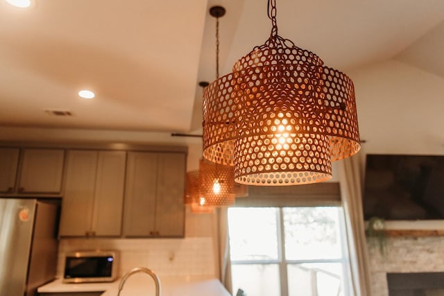 interior details featuring appliances with stainless steel finishes, recessed lighting, and a fireplace
