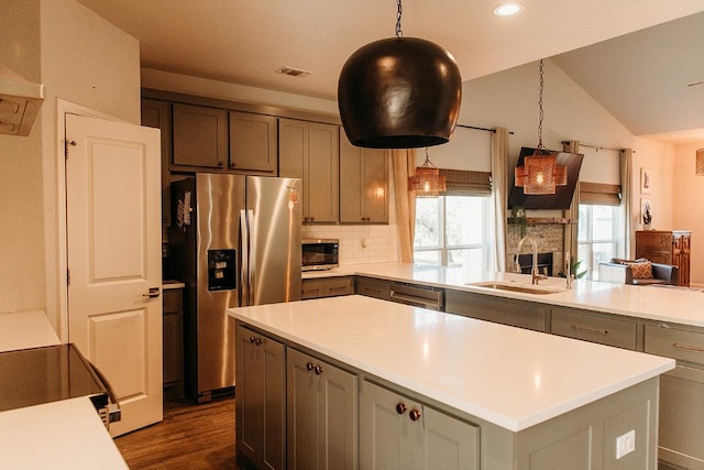 kitchen with stainless steel appliances, visible vents, light countertops, and a sink