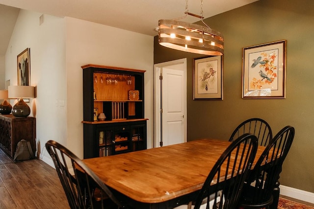 dining space with wood finished floors and baseboards