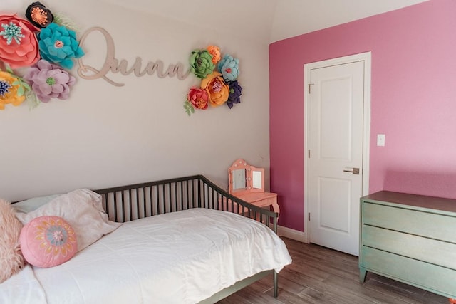 bedroom with baseboards and wood finished floors