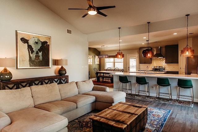 living room with ceiling fan, recessed lighting, visible vents, vaulted ceiling, and dark wood finished floors