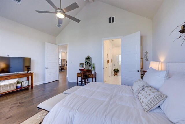 bedroom featuring visible vents, high vaulted ceiling, baseboards, and wood finished floors