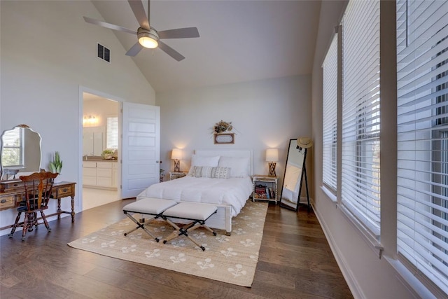 bedroom with visible vents, multiple windows, high vaulted ceiling, and wood finished floors