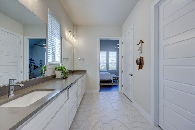 ensuite bathroom featuring tile patterned floors, a ceiling fan, ensuite bathroom, a sink, and double vanity