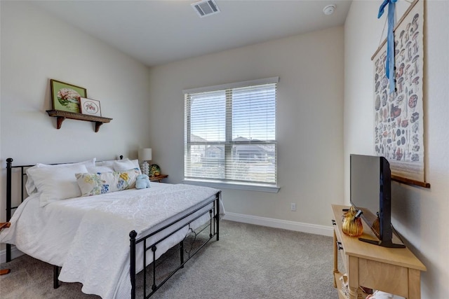 carpeted bedroom featuring visible vents and baseboards