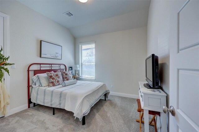 carpeted bedroom with lofted ceiling, visible vents, and baseboards