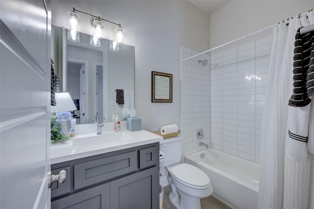 bathroom with tile patterned floors, toilet, shower / bath combo with shower curtain, and vanity