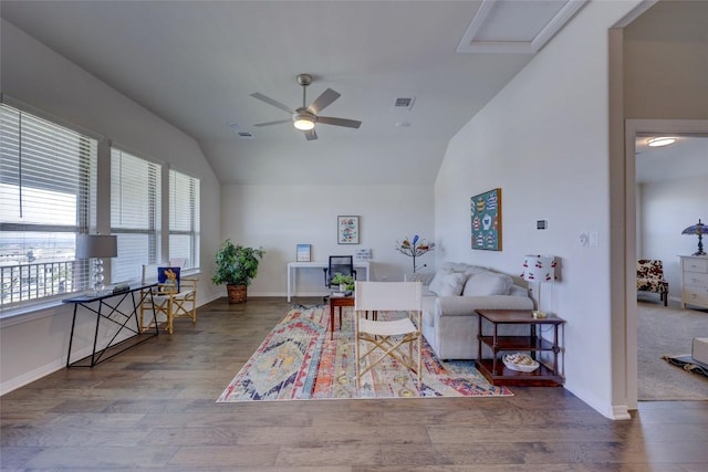 living room featuring visible vents, wood finished floors, a ceiling fan, and vaulted ceiling