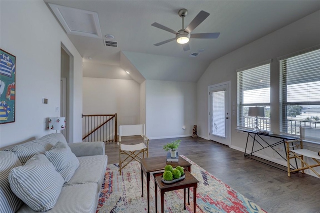 living room with visible vents, baseboards, lofted ceiling, and wood finished floors