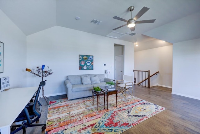 living area with visible vents, baseboards, wood finished floors, and vaulted ceiling