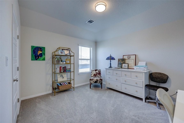 interior space with a textured ceiling, baseboards, visible vents, and light carpet