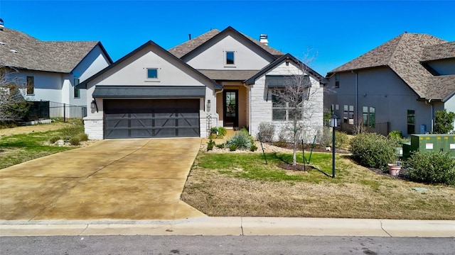 view of front of house featuring roof with shingles, an attached garage, driveway, and stucco siding