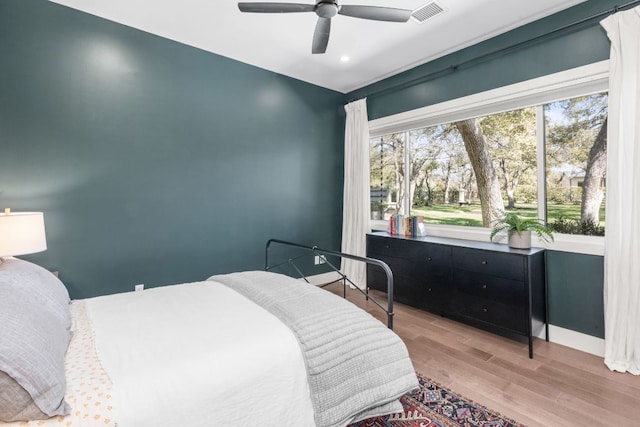 bedroom with wood finished floors, visible vents, baseboards, recessed lighting, and ceiling fan