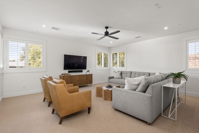 living area featuring recessed lighting, visible vents, and baseboards