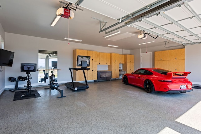 garage featuring a garage door opener and baseboards