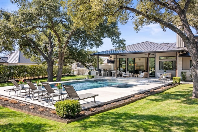 pool featuring a patio, a lawn, a ceiling fan, and fence