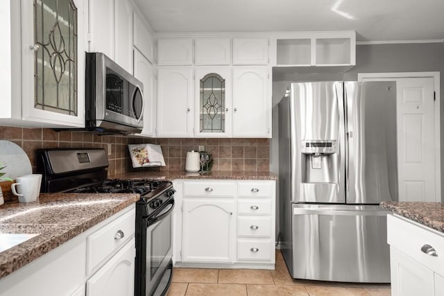 611 Virginia Dr, Round Rock, TX 78664 - kitchen with stainless steel appliances, white cabinetry, tasteful backsplash, glass insert cabinets, and ornamental molding