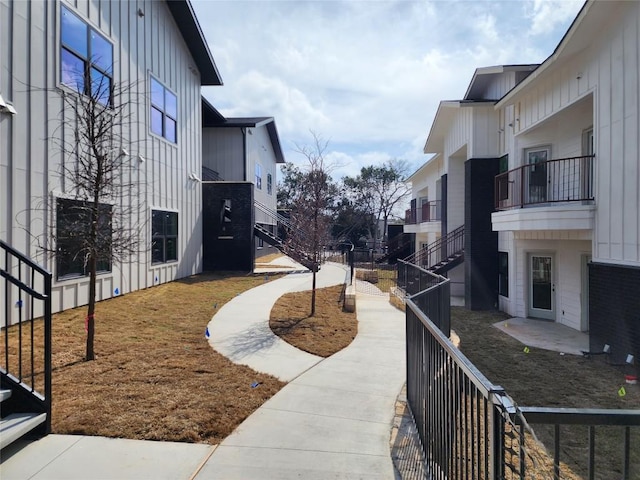 view of property's community featuring stairs and fence