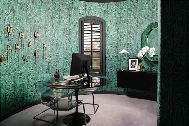 home office with baseboards and wallpapered walls