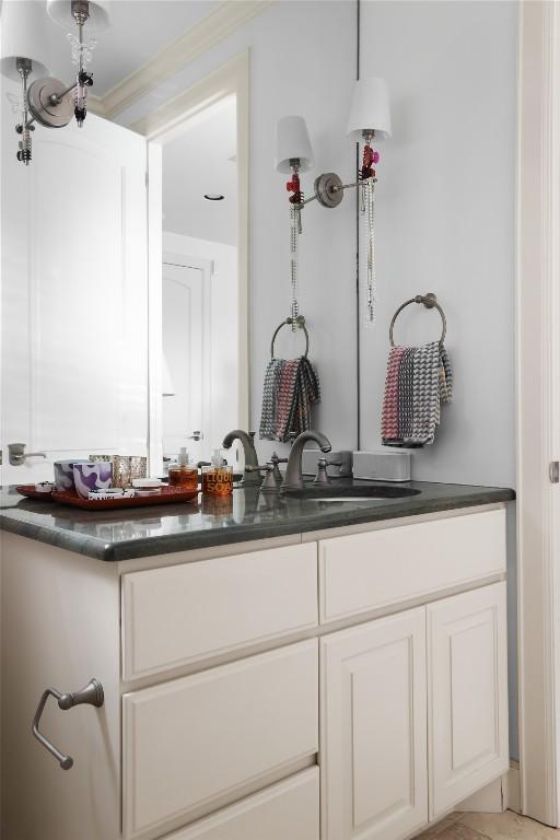 bathroom with crown molding and a sink