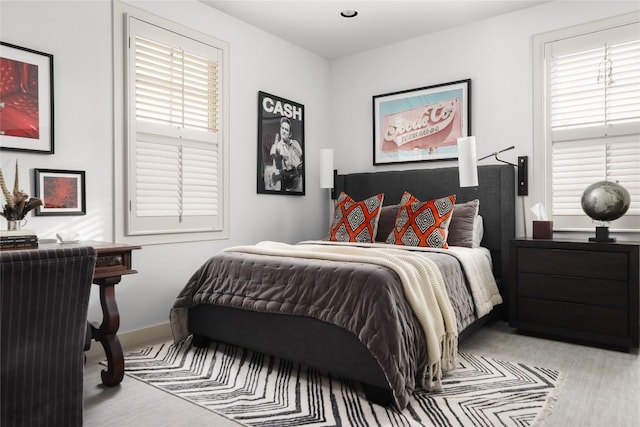 bedroom with multiple windows and baseboards