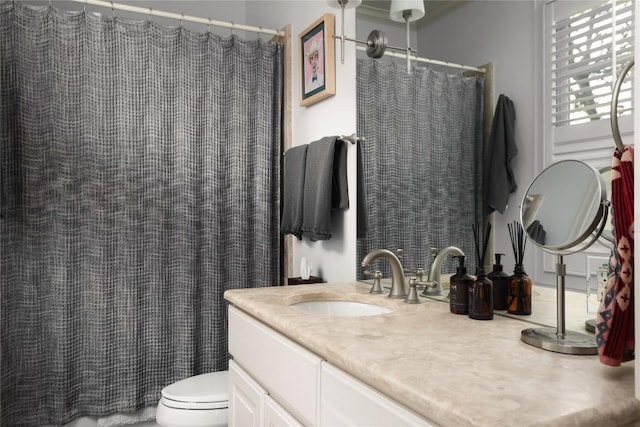 bathroom with toilet, vanity, and a shower with curtain