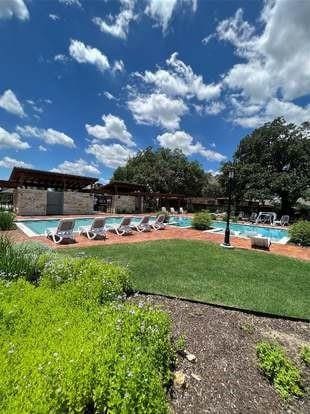 surrounding community featuring a pool and a yard