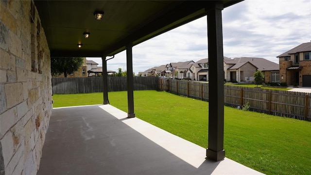 view of patio with a fenced backyard and a residential view