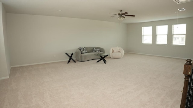 sitting room with attic access, visible vents, carpet floors, and baseboards