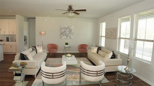 living area featuring dark wood-style floors, ceiling fan, and baseboards