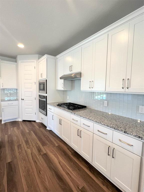 kitchen with white cabinets, dark wood-style floors, and stainless steel appliances