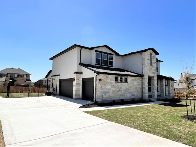 view of front facade featuring driveway, stone siding, an attached garage, fence, and stucco siding