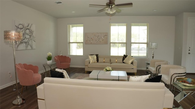 living area featuring visible vents, baseboards, and wood finished floors