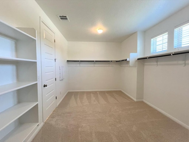 walk in closet featuring carpet floors and visible vents