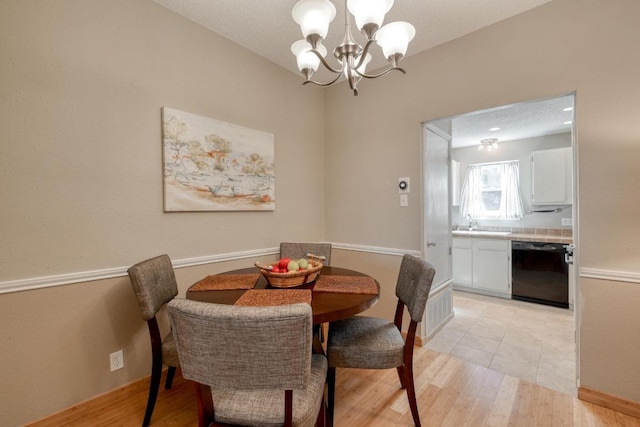 dining room featuring an inviting chandelier and light wood-style floors