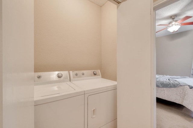 laundry room featuring a ceiling fan, laundry area, washer and clothes dryer, and a textured ceiling