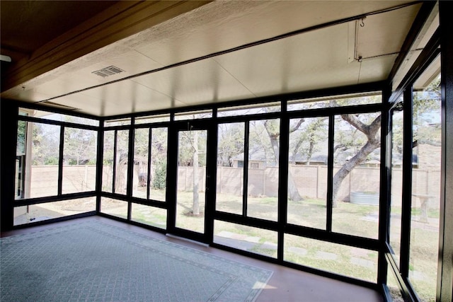 unfurnished sunroom featuring a wealth of natural light