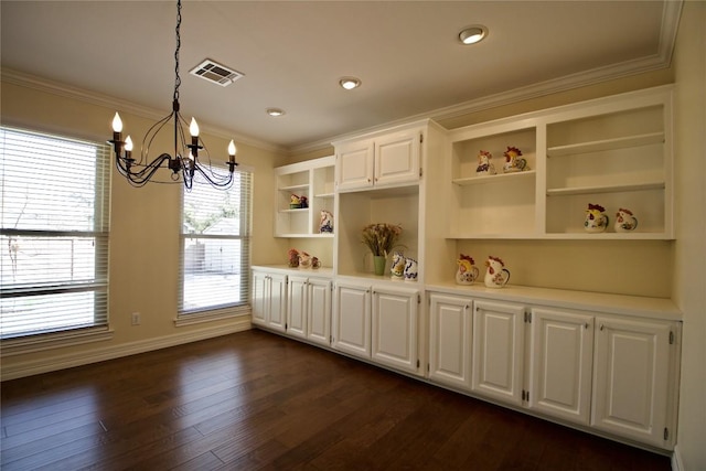 interior space with visible vents, light countertops, ornamental molding, dark wood-style floors, and open shelves