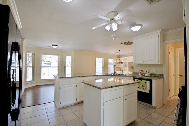 kitchen with light tile patterned flooring, a peninsula, a sink, black appliances, and crown molding