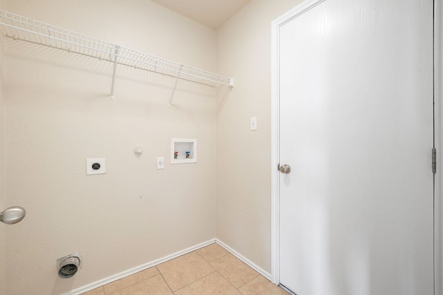 laundry room featuring laundry area, light tile patterned floors, gas dryer hookup, hookup for an electric dryer, and washer hookup